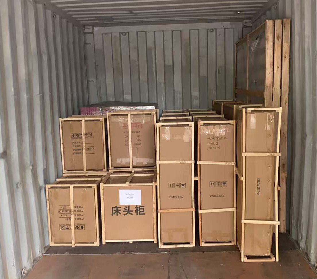 Items packed in wooden frames inside shipping container